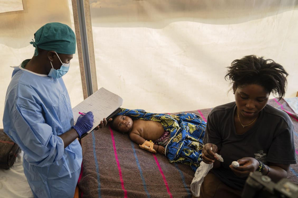 A health worker attends to a girl suffering from mpox, at a treatment centre in Munigi, eastern Congo. (File/AP)