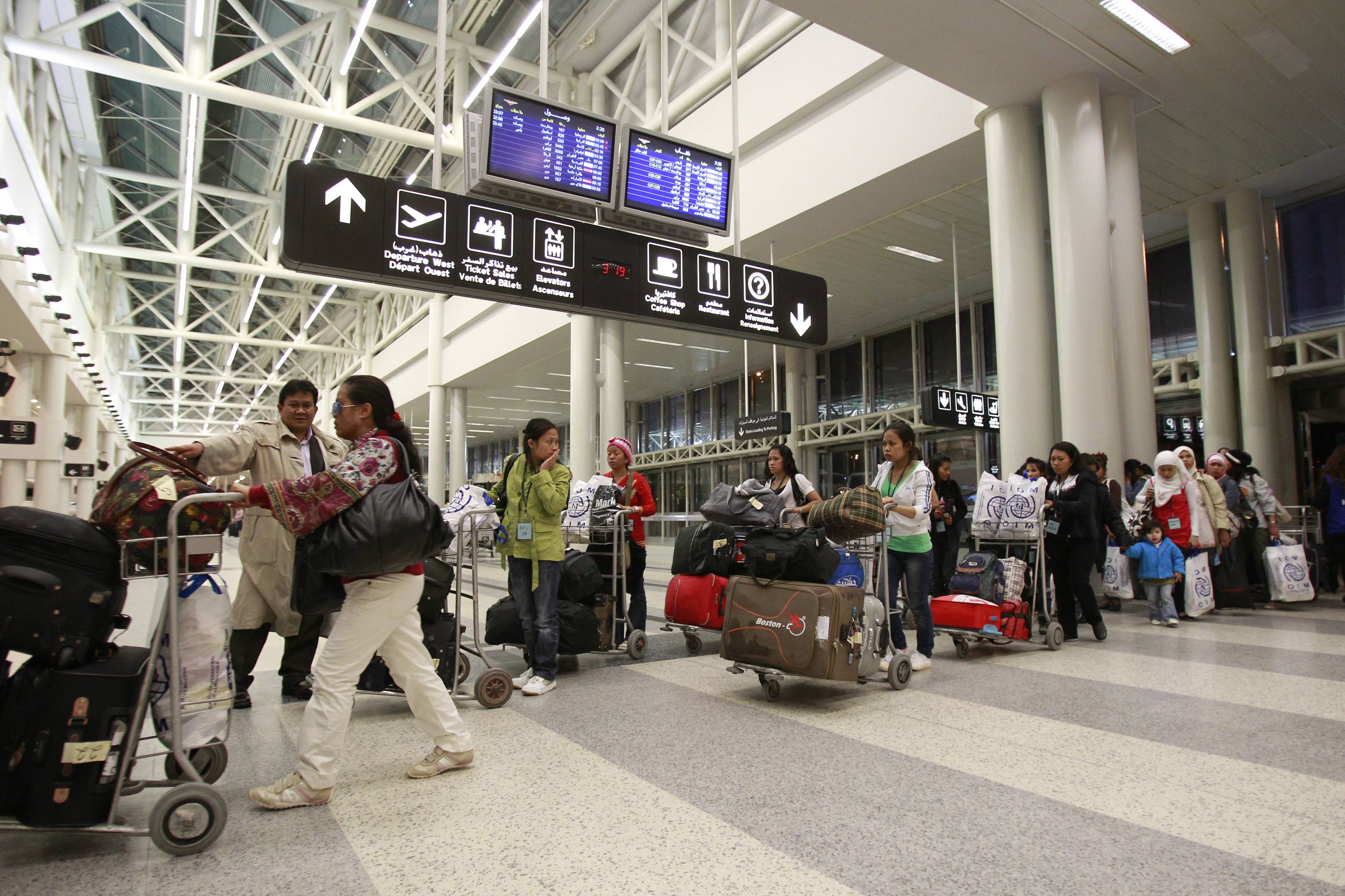 Filipino nationals leave Beirut international airport on their way back home on December 12, 2012. (File/AFP)