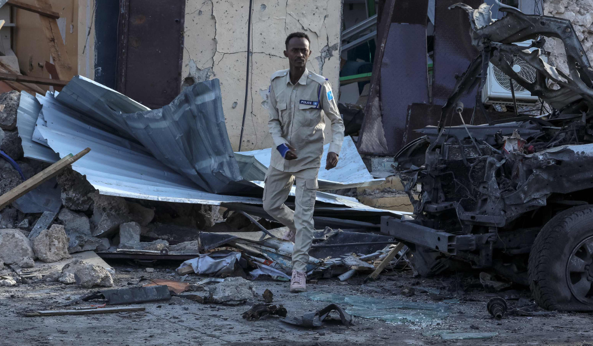 A Somalian police officer looks at debris and destruction at a cafe in Mogadishu on July 15, 2024 following a car bomb blast. (AFP)