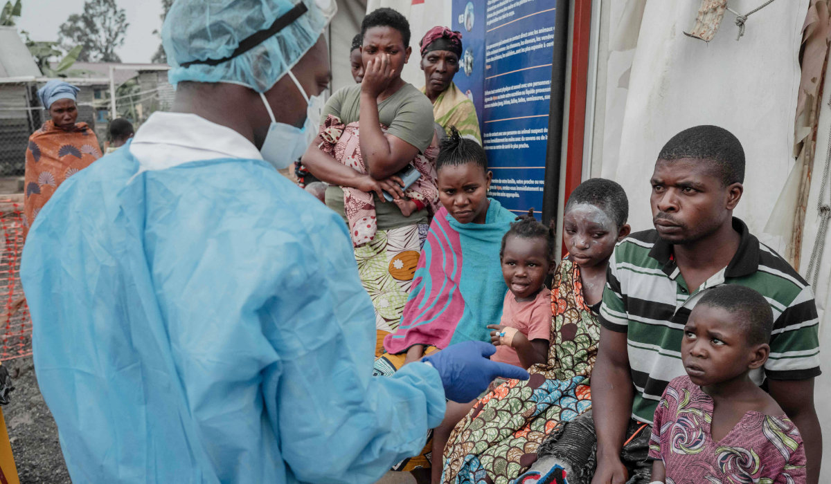 Patients listen to a doctor outside the consultation room of the Mpox treatment centre at Nyiragongo General Referral Hospital, north of Goma on August 17, 2024. (AFP)