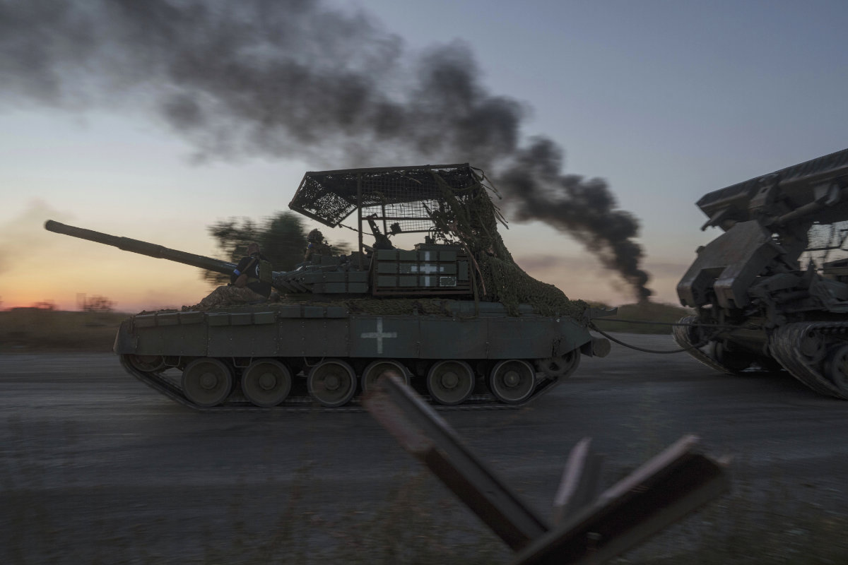 Ukrainian servicemen ride atop on a tank after returning from Russia near the Russian-Ukrainian border in Sumy region, Ukraine, on Aug. 17, 2024. (AP)