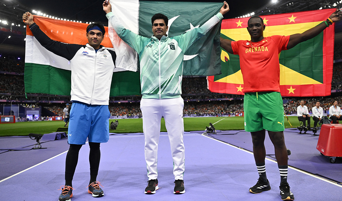Silver medallist India's Neeraj Chopra, Gold medallist Pakistan's Arshad Nadeem and Bronze medallist Grenada's Anderson Peters celebrate after competing in the men's javelin throw final of the athletics event at the Paris 2024 Olympic Games at Stade de France in Saint-Denis, north of Paris, on August 8, 2024. (AFP/File)