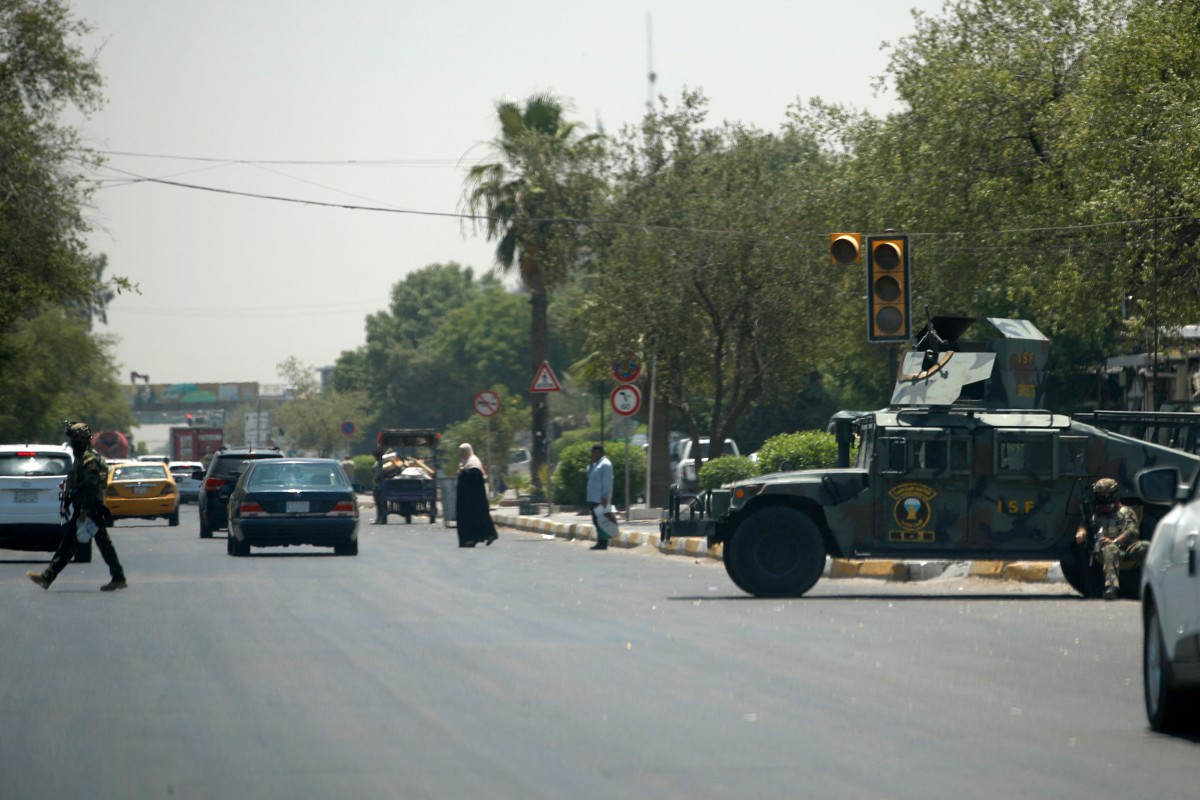 Iraqi security forces secure Palestine Street the day after some 30 people attacked two restaurants, including the American KFC, in Baghdad on June 4, 2024. (AFP)