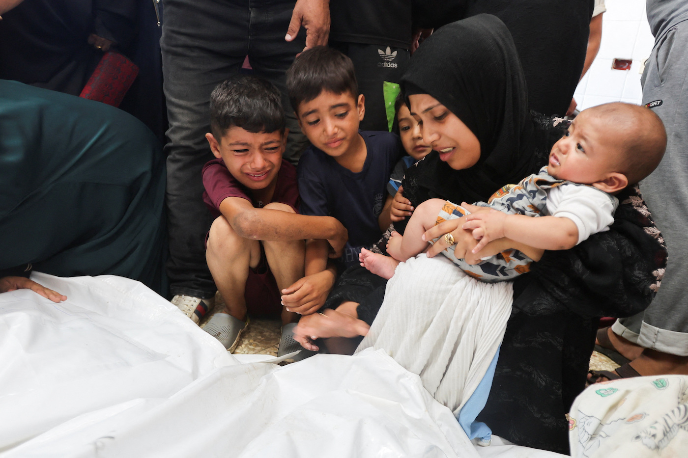 Mourners react next to the bodies of Palestinians killed in Israeli strikes at Al-Aqsa Martyrs Hospital in Deir Al-Balah in the central Gaza Strip, August 18, 2024. (Reuters)