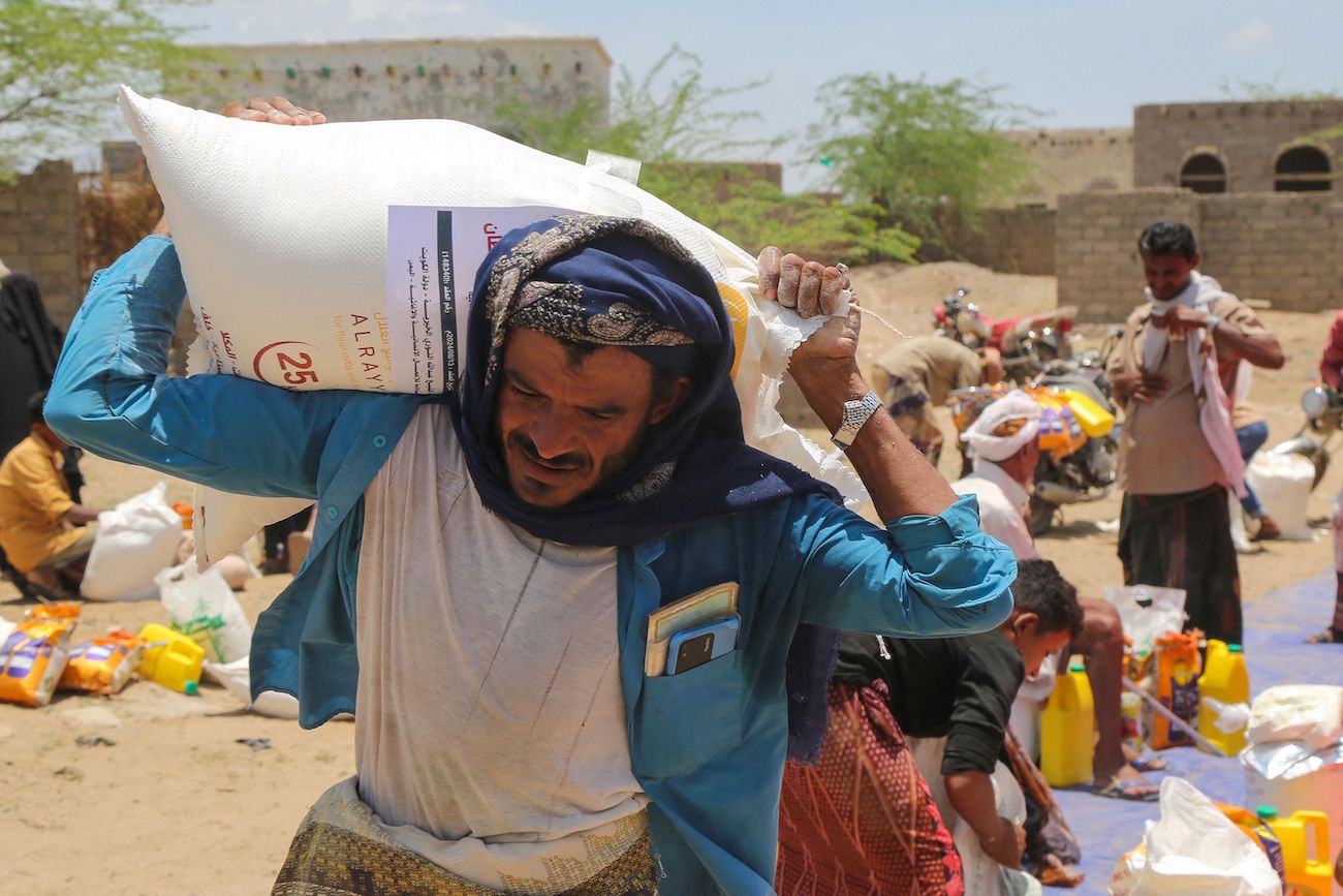 Displaced Yemenis affected by recent floods receive humanitarian aid in the Hays region, south of Hodeidah Governorate, August 16, 2024. (AFP)