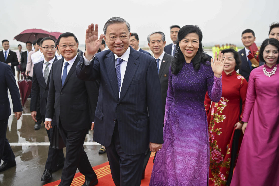 Vietnamese President To Lam, center left, waves as he arrives in Guangzhou, south China's Guangdong Province, as he starts his three-day official visit to China. (AP)