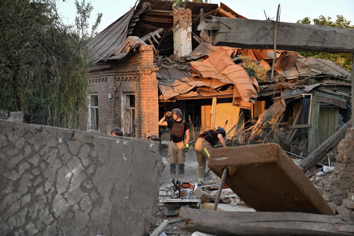 Rescuers clear debris of a house destroyed following a strike in the town of Bilopillya, near the Russian border in the Sumy region on Aug. 18, 2024. (AFP)
