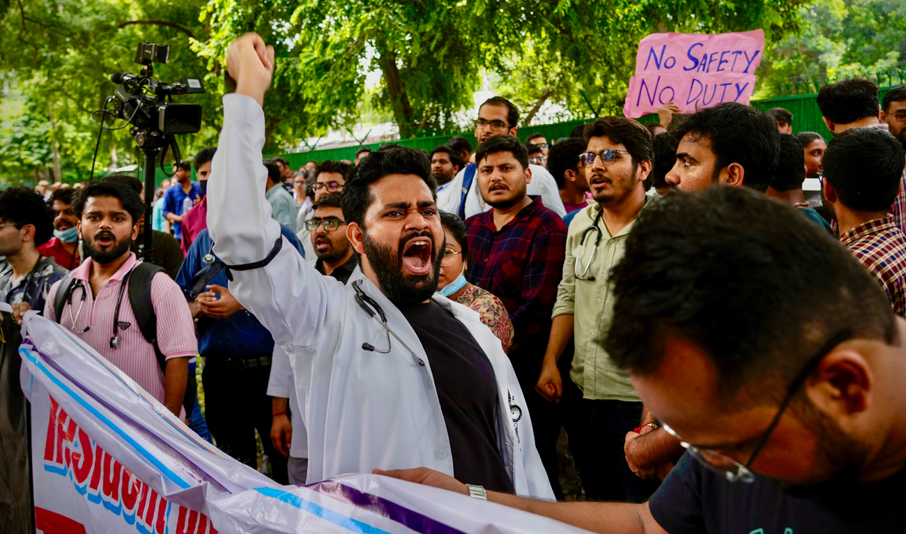 Doctors and paramedics protesting against the rape and killing of a trainee doctor at a government hospital in Kolkata gather in front of the Indian health minister’s office, in New Delhi on August 19, 2024. (AP)