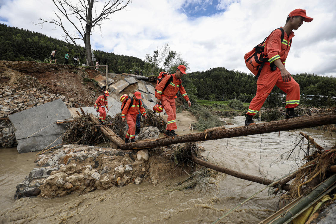 Members of a rescue team walk to a flood-affected area in Zixing, in central China’s Hunan province. (File/AFP)