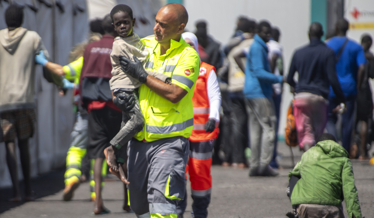 An emergency team member carries a child rescued from a boat in the port of La Restinga on the Canary Island of El Hierro, Spain. (AP)