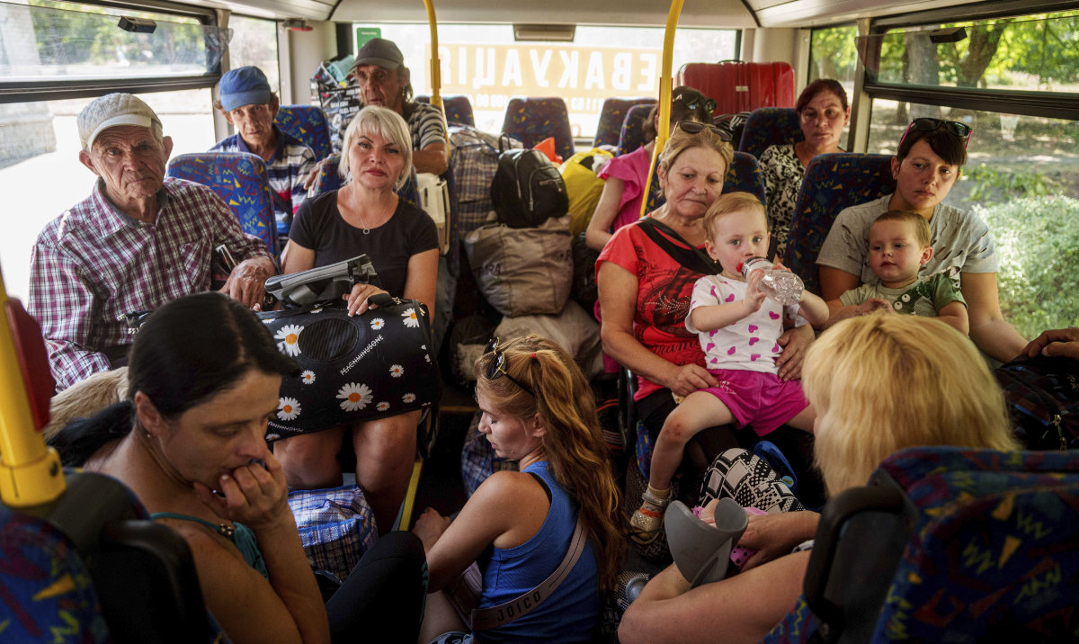People sit in a bus during evacuation in Pokrovsk, Donetsk region, Ukraine, Monday, August 19, 2024. (AP)