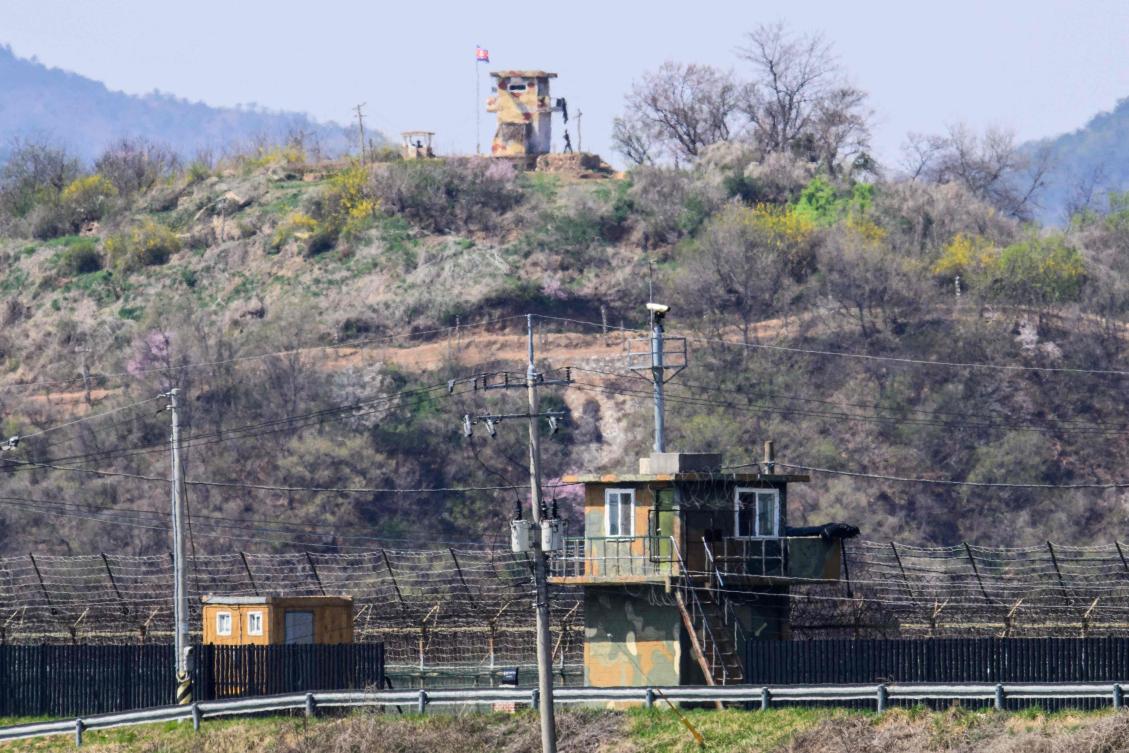 Above, soldiers, top outside a guard post in North Korea as seen beyond a South Korean guard post, bottom, from the South Korean border city of Paju. (AFP)