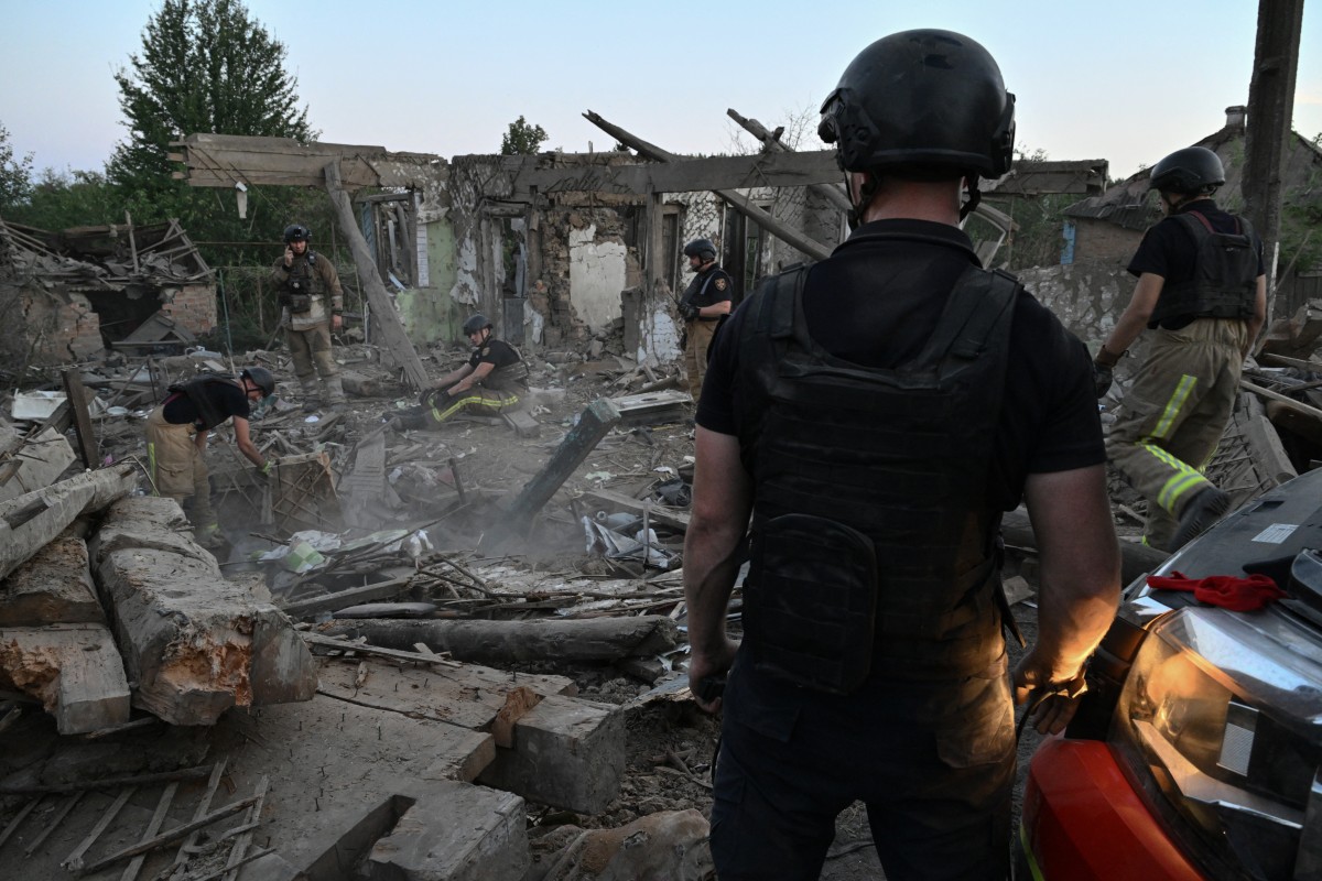 escuers clear debris of a house destroyed following a strike in the town of Bilopillya, near the Russian border in the Sumy region, on August 18, 2024, amid the Russian invasion of Ukraine(AFP)