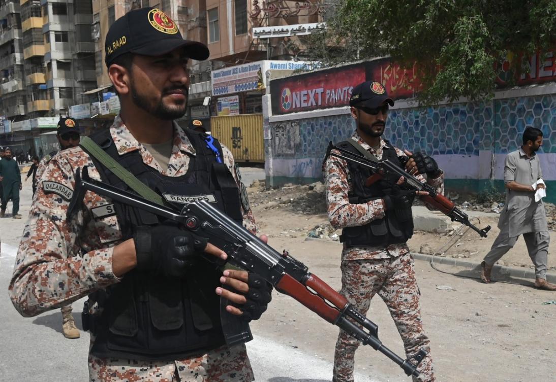 Security personnel patrol along a street during a procession to commemorate the martyrdom of Imam Ali, the cousin and son-in-law of Prophet Mohammed, during the holy month of Ramadan in Karachi on April 1, 2024. (File/AFP)