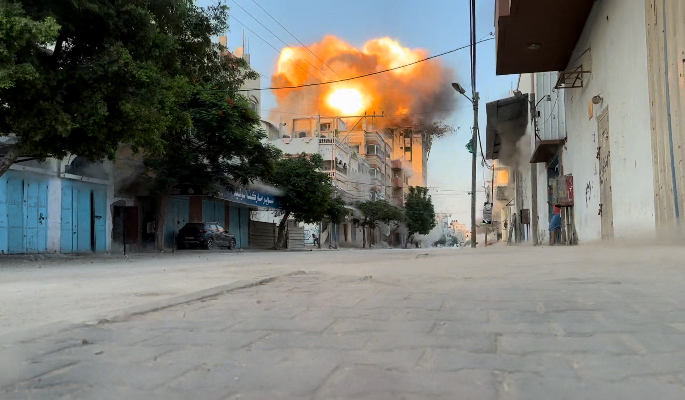 Smoke and flames rise following an Israeli strike on a residential building, amid the ongoing conflict between Israel and Hamas, Nuseirat in the central Gaza Strip, in this screen grab taken from a video, August 18, 2024. (Reuters TV)