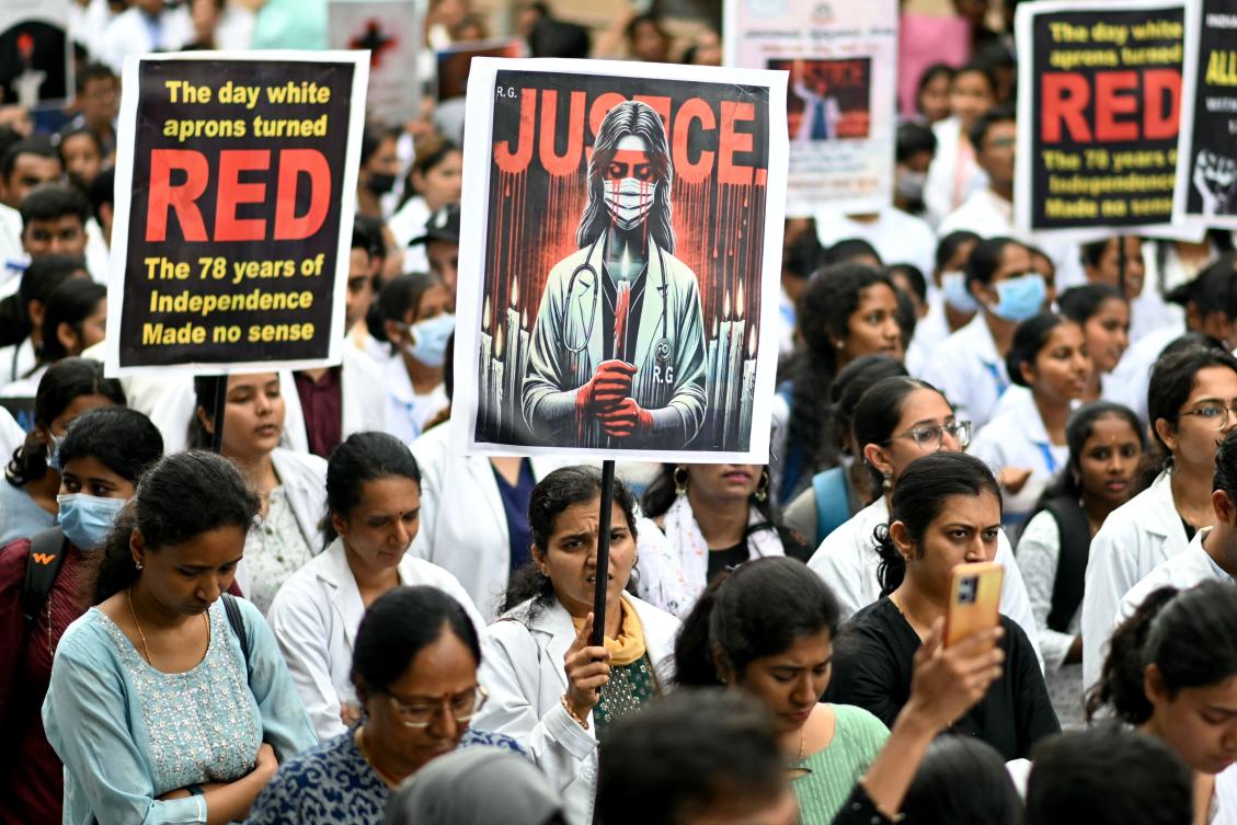 Medical professionals hold posters amid nationwide strike by doctors to condemn the rape and murder of a young medic from Kolkata, at a hospital in Bengaluru on August 17, 2024. (AFP)