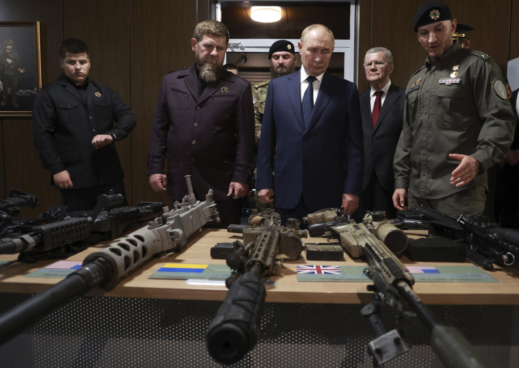 Russian President Vladimir Putin, center, inspects NATO military trophies captured in the battles in Ukraine, during his visit to the Russian Special Forces University in Gudermes, Chechen Republic on Aug. 20, 2024. (Sputnik/Kremlin Pool Photo via AP)