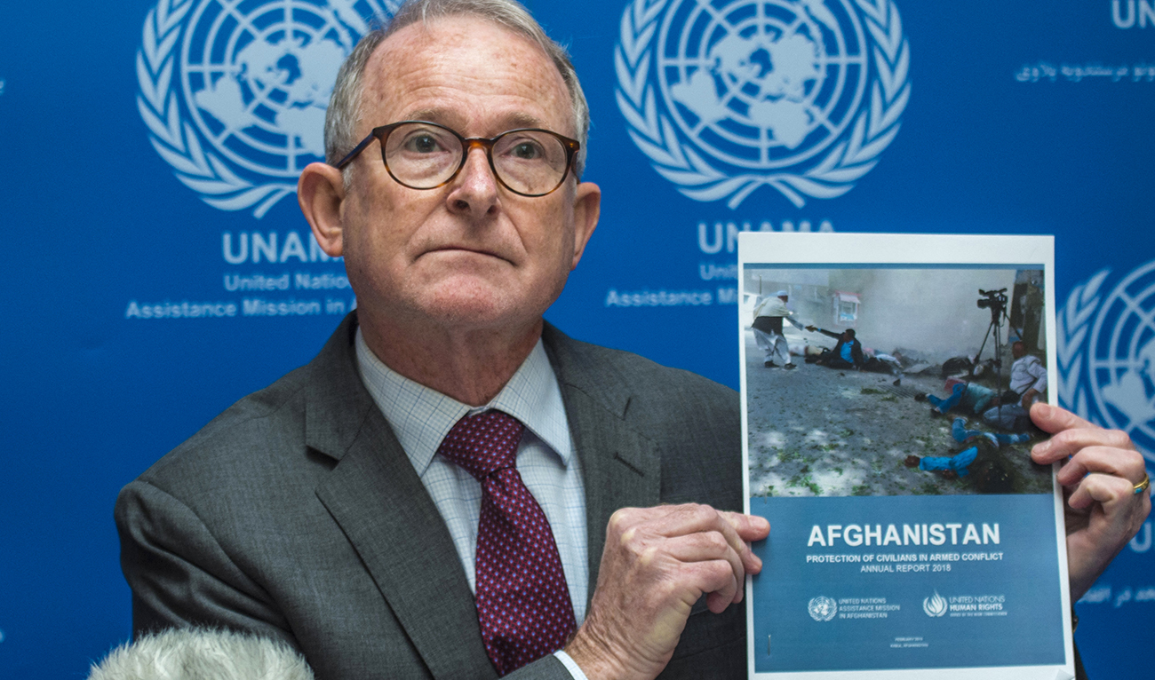 Richard Bennett, head of the UN Assistance Mission in Afghanistan (UNAMA) human rights unit, holds up a copy of 'UN 2018 Annual Report on the Protection of Civilians in Armed Conflict in Afghanistan' at a press conference in Kabul on February 24, 2019. (AFP/File)