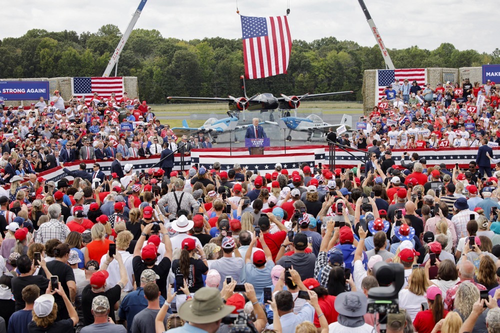 Republican presidential nominee and former U.S. President Donald Trump speaks from a bulletproof glass housing during a campaign rally, at the North Carolina Aviation Museum & Hall of Fame in Asheboro, North Carolina. (Reuters)