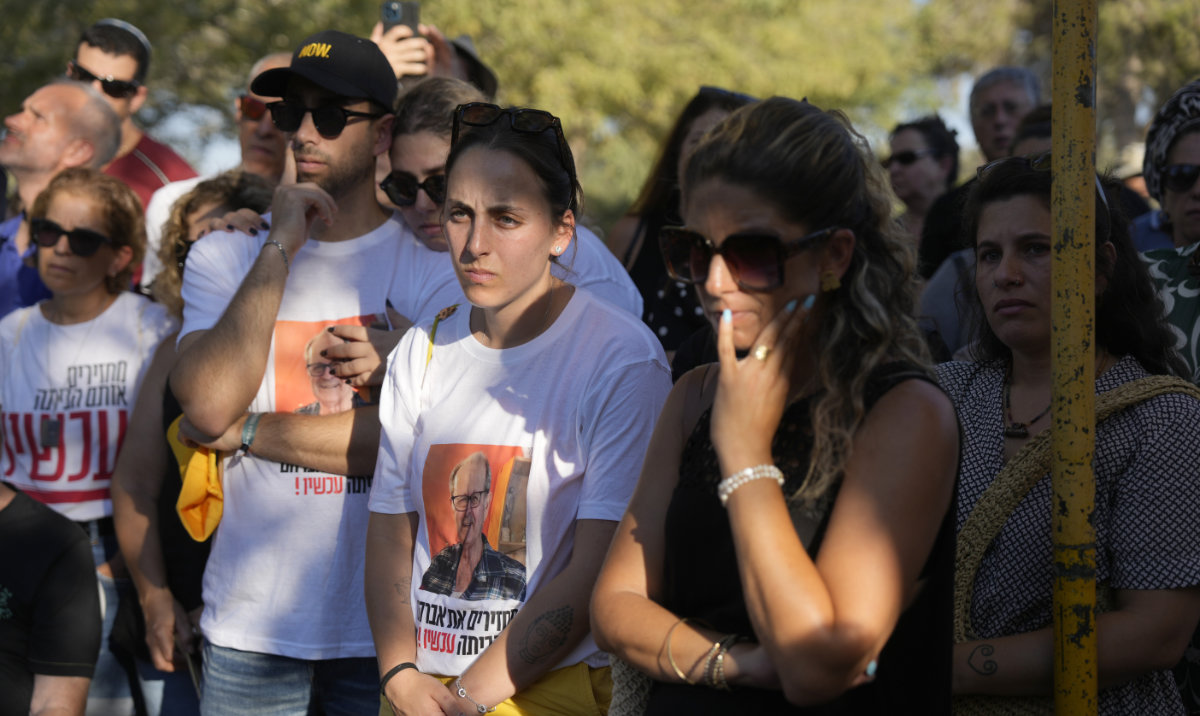 Mourners attend the funeral for slain hostage Avraham Munder, who was killed in Hamas captivity in the Gaza Strip, at Kibbutz Nir Oz, southern Israel, Wednesday, Aug. 21, 2024. His son, Roee, who was killed on Oct. 7, 2023, was reburied at the Kibbutz. On Tuesday, the Israeli military said its forces recovered six bodies of hostages kidnapped on Oct. 7 in an overnight operation in southern Gaza. (AP)
