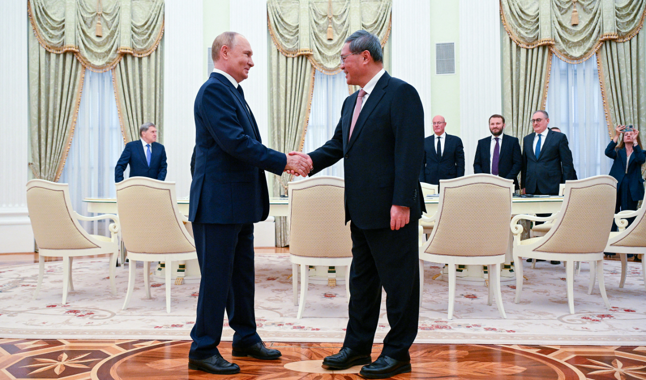 In this pool photograph distributed by the Russian state agency Sputnik, Russia's President Vladimir Putin (L) meets Premier of the State Council of China Li Qiang in Moscow on August 21, 2024. (AFP)