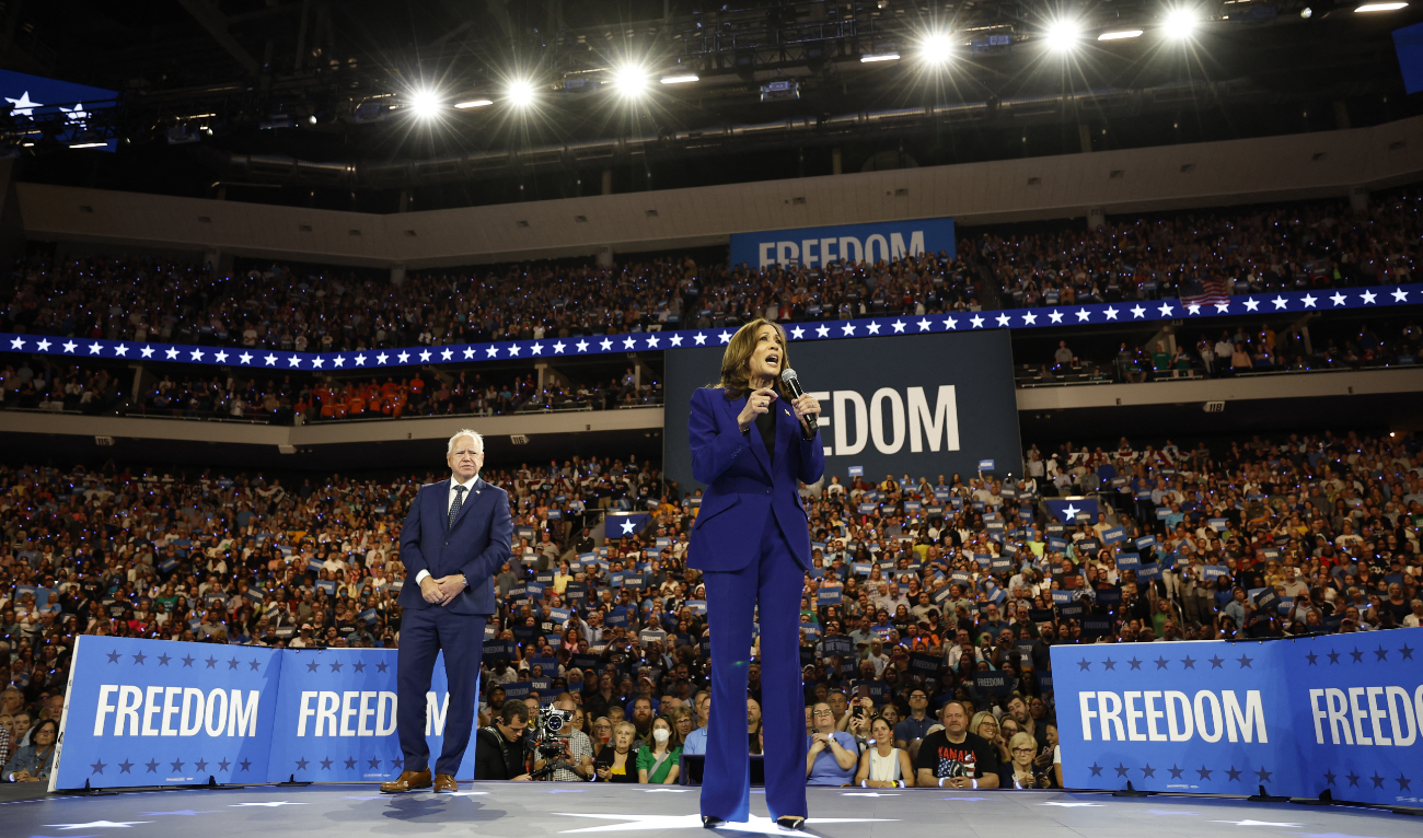 US Vice President and Democratic presidential candidate Kamala Harris speaks as Minnesota Governor and Democratic vice presidential candidate Tim Walz listens during a campaign rally at Fiserv Forum in Milwaukee, Wisconsin, August 20, 2024. (AFP)