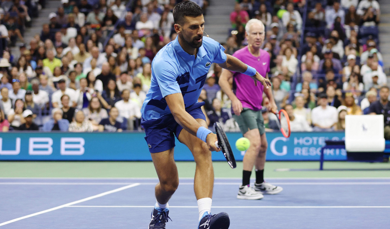 Former tennis professional John McEnroe of the US and Novak Djokovic of Serbia play against former tennis professional Andre Agassi of the US and Carlos Alcaraz of Spain (not pictured) during the Stars of the Open exhibition match on Aug. 21, 2024. (AFP)