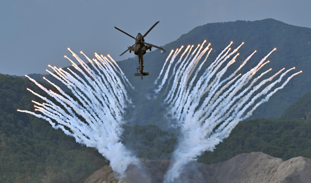 South Korea's Apache AH-64 helicopter fires flares during a South Korea-US joint military drill at Seungjin Fire Training Field in Pocheon on June 15, 2023. (AFP/File)