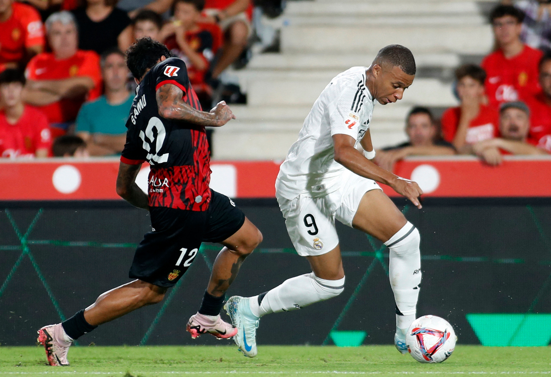 Real Madrid’s French forward #9 Kylian Mbappe vies for the ball with Real Mallorca’s Portuguese midfielder Samu Costa during the Spanish league football match between RCD Mallorca and Real Madrid CF. (AFP)