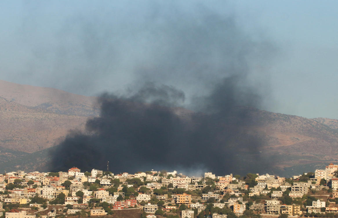 Smoke rises near buildings in Khiam, amid cross-border hostilities between Hezbollah and Israeli forces, as pictured from Marjayoun, near the border with Israel, Lebanon August 23. (Reuters)