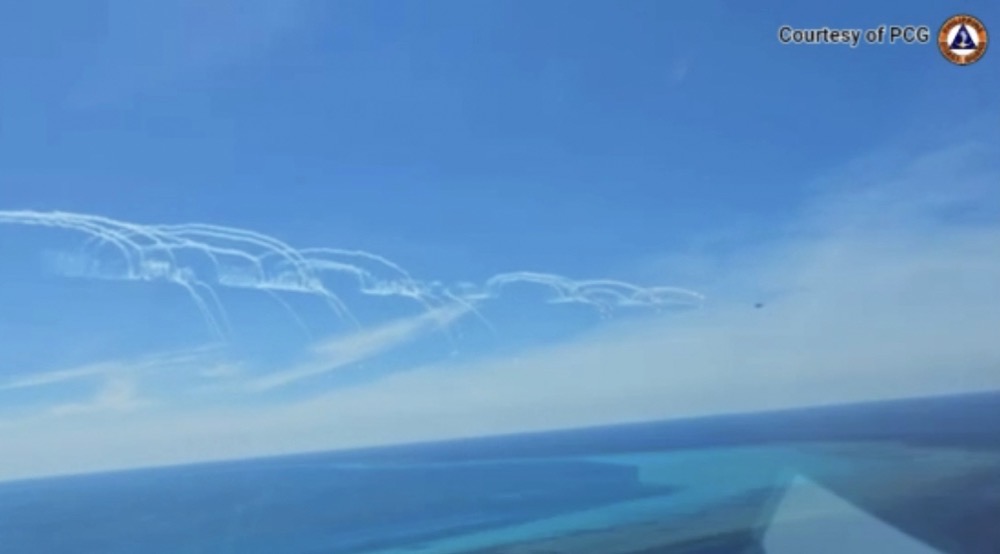 A Chinese air force fighter jet deploys flares near a Philippine Bureau of Fisheries and Aquatic Resources (BFAR) plane. (AFP PHOTO / Philippine Coast Guard)