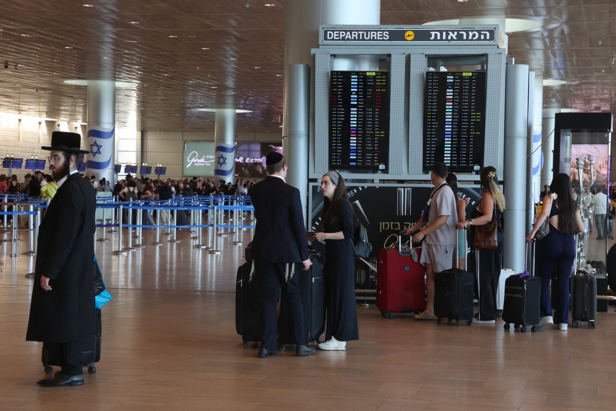 Passengers wait for their fligts at Ben Gurion airport near Tel Aviv on August 6, 2024. (AFP)