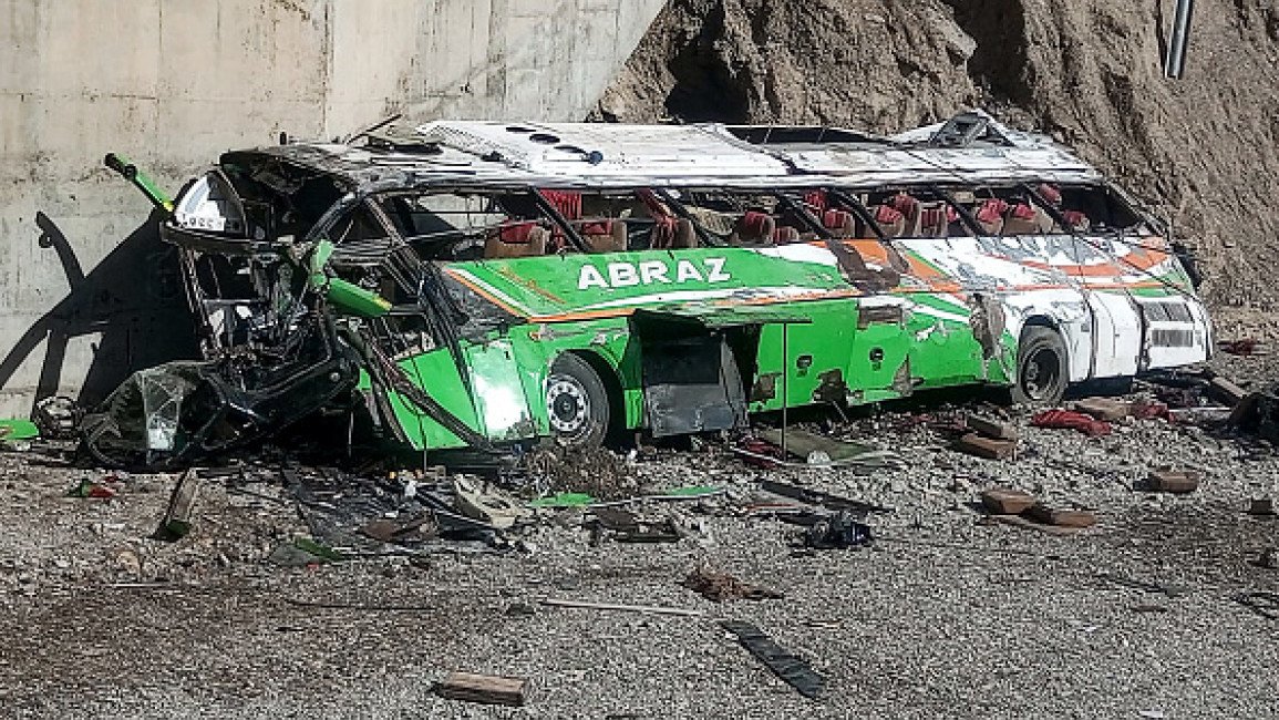 A general view of the wrecked bus is seen after it crashed along a mountainous area in Basima town of Balochistan province on May 29, 2024. (AFP)