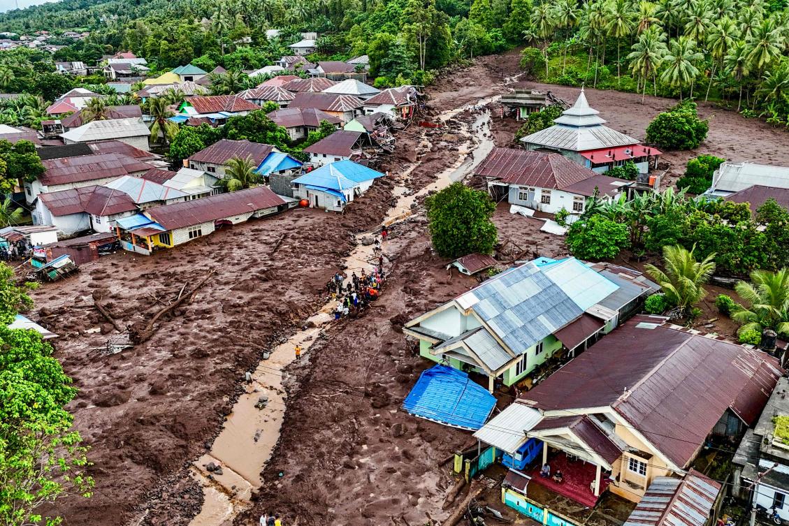 This aerial view shows rescue teams and residents searching for victims buried in mud after a flashflood hit the village of Rua located at the foot of Mount Gamalama, in Ternate, North Maluku. (AFP)