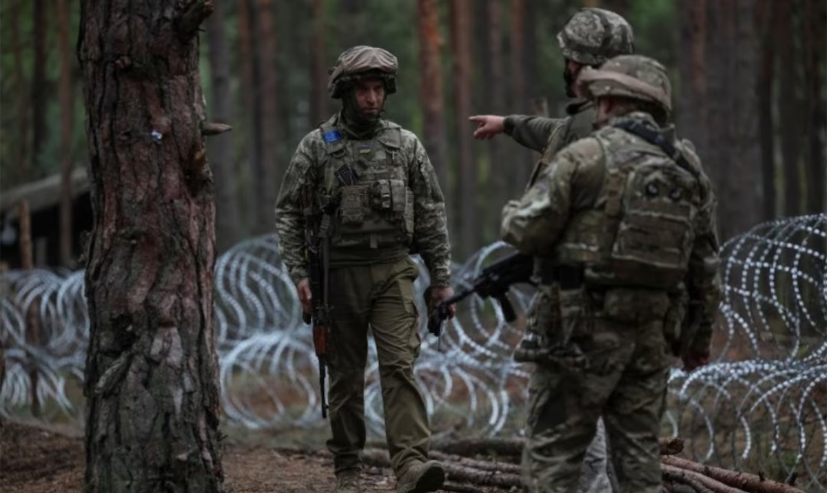 Ukrainian servicemen are seen at their position near the border with Belarus, amid Russia's attack on Ukraine, in Zhytomyr region, Ukraine. (Reuters)