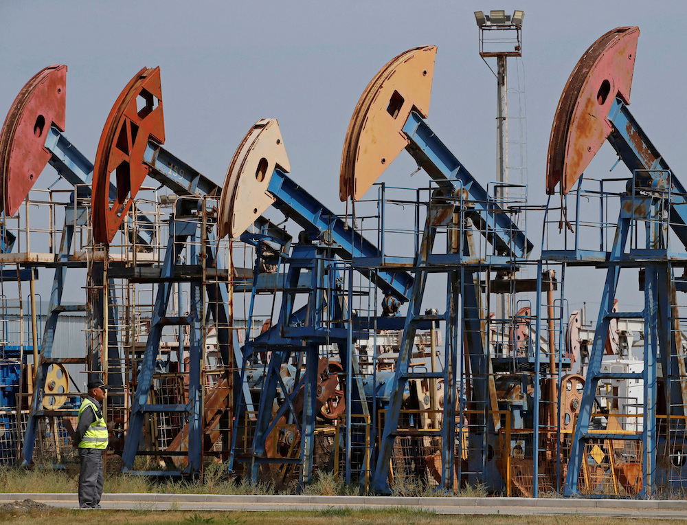 A security guard stands near disused oil pump jacks at the Airankol oil field operated by Caspiy Neft in the Atyrau Region, Kazakhstan Aug. 22, 2024. Reuters