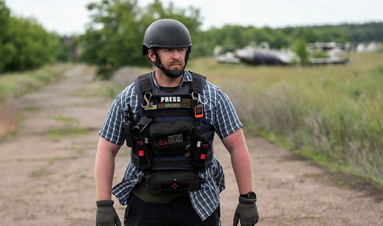 Reuters safety advisor Ryan Evans stands in a field while working with a news reporting team in an undated photo taken in Ukraine. (AFP)