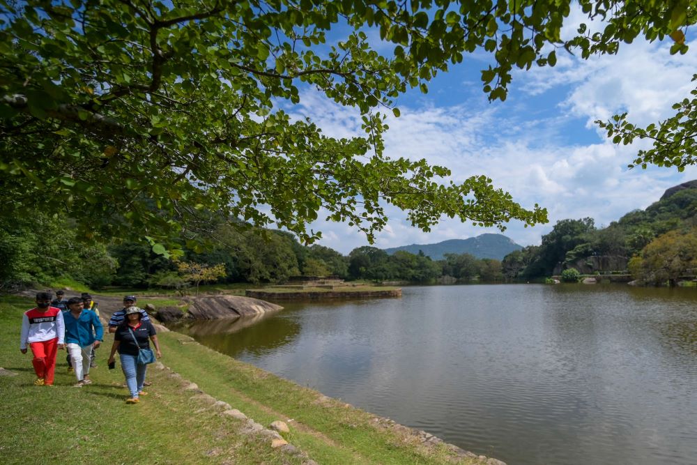 Tourists visit the Blackwater pond in Mihintale near Anuradhapura on Feb. 11, 2023. (AFP)