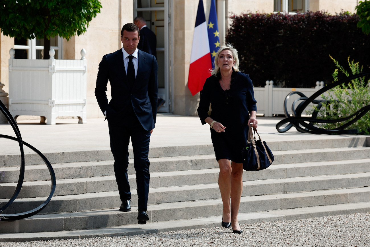 French far-right leader Marine Le Pen, member of parliament for the Rassemblement National party and Jordan Bardella, President of the French far-right Rassemblement National party, walk outside the Elysee Palace on August 26, 2024. (Reuters)