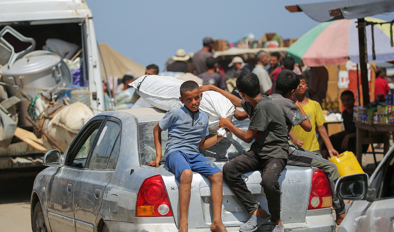 Displaced Palestinians leave the perimeter of the Al-Aqsa Martyrs Hospital in Deir al-Balah in the central Gaza Strip following renewed Israeli evacuation orders for the area on August 26, 2024. (AFP)