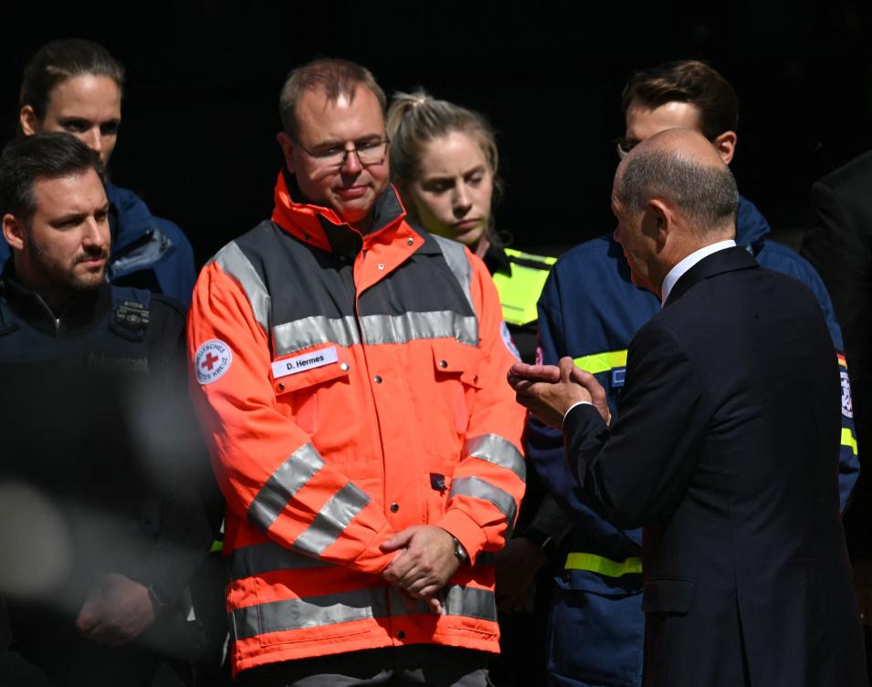 German Chancellor Olaf Scholz speaks with deployment forces at the site of a knife attack in Solingen, western Germany, on August 26, 2024. (AFP)