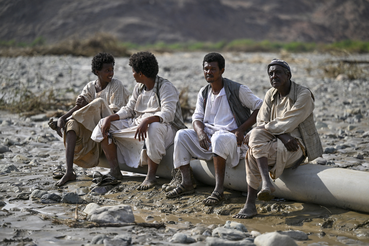 Sudanese people look on as they sit on debris after the collapse of the Arbaat Dam, 40km north of Port Sudan following heavy rains and torrential floods on August 25, 2024. (File/AFP)
