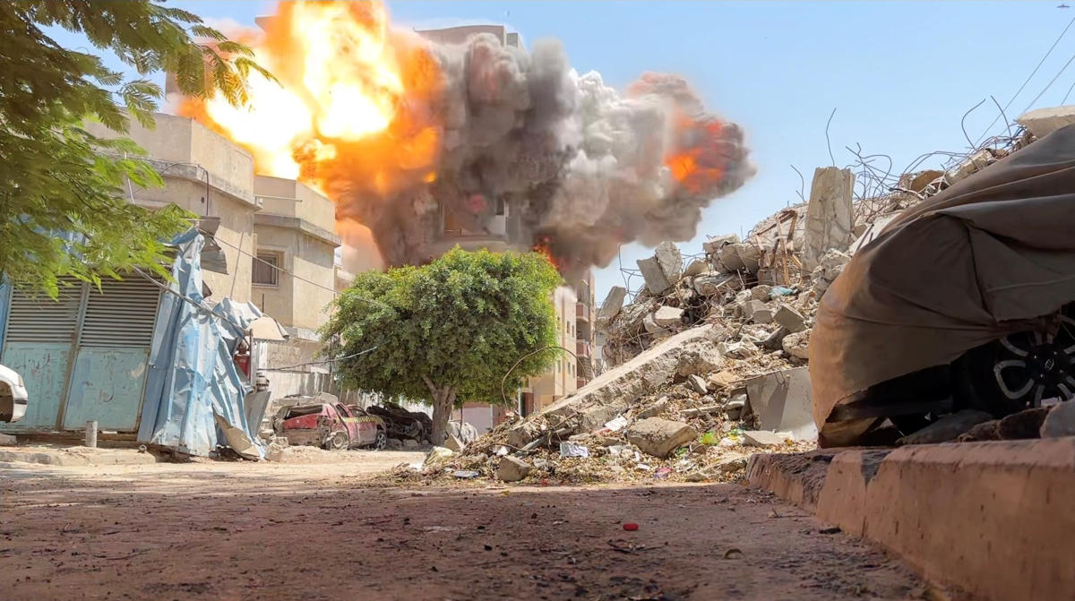 Smoke and flames rise from a house hit by an Israeli strike in Nuseirat refugee camp, in the central Gaza Strip, in this still picture taken from a video on Aug. 27, 2024. (Reuters TV)