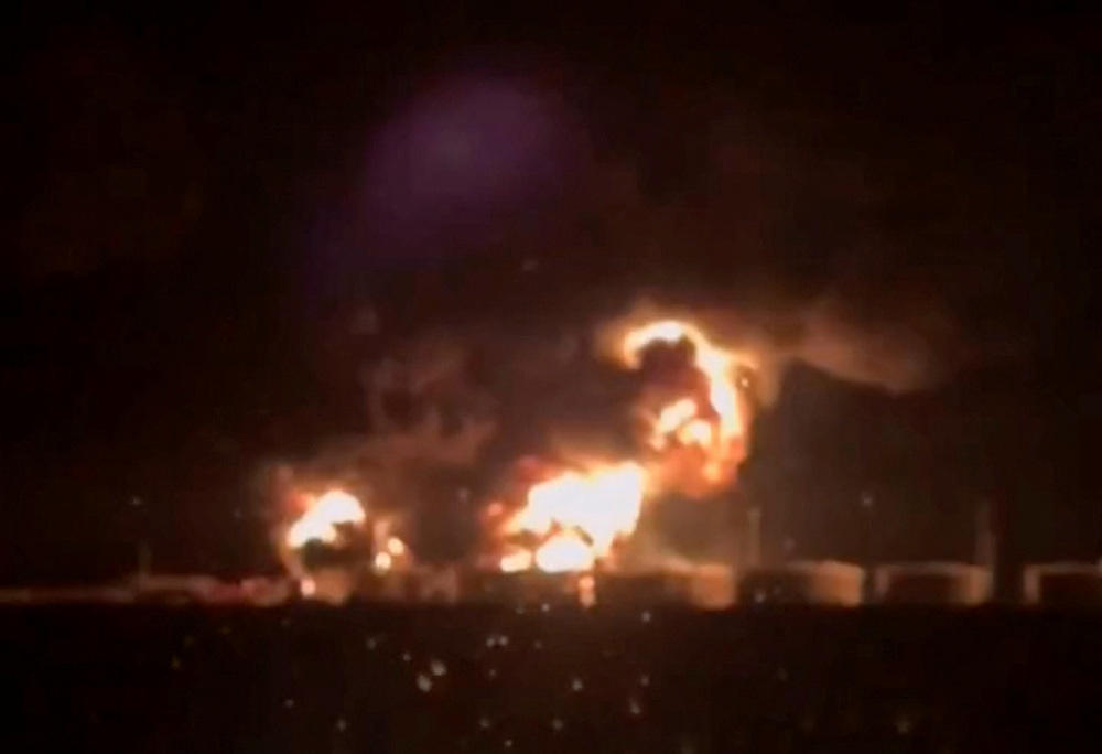 Above, a screen grab from a social media video released on Aug. 28, 2024 shows fire in the oil tanks at the Glubokinskaya oil depot at Kamensky district, Rostov Region, Russia. (via Reuters)