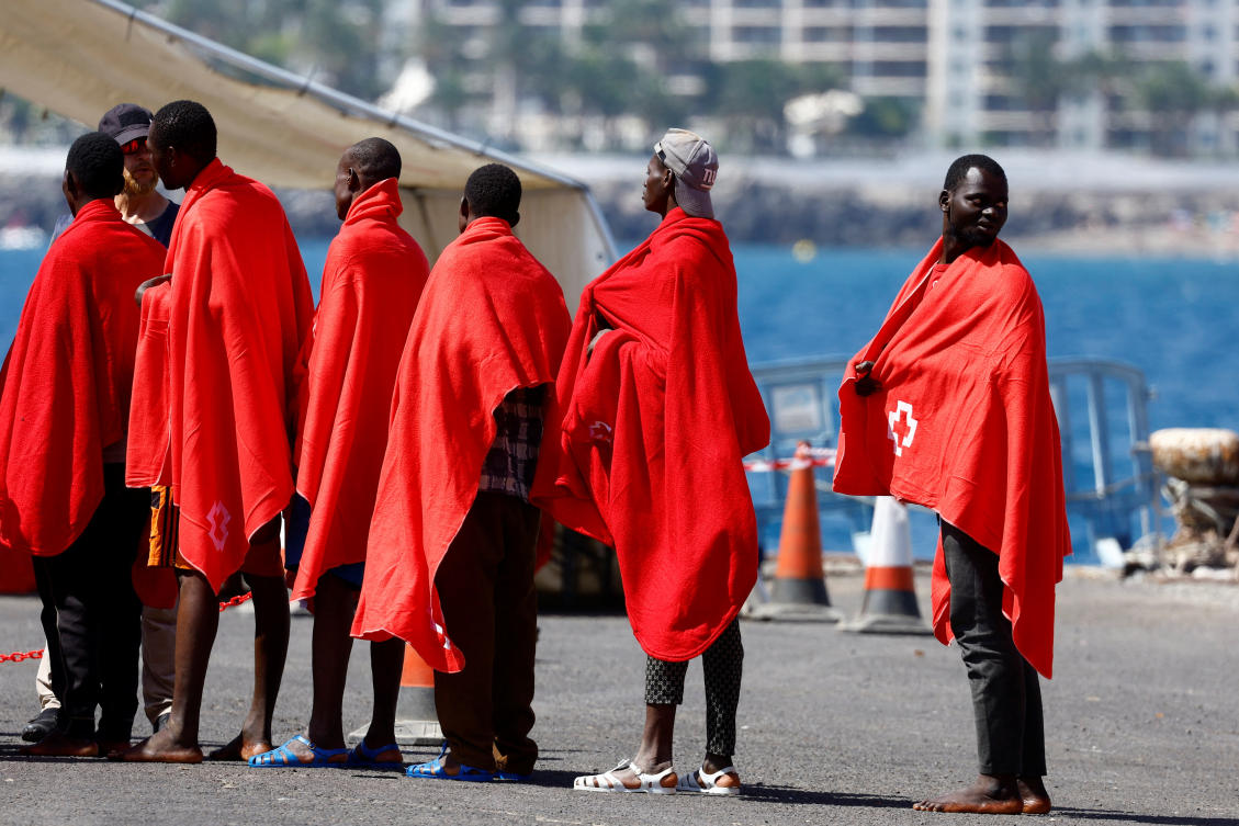 Migrants wait to be treated by the Red Cross after disembarking from a Spanish coast guard vessel at the port of Arguineguin, on the island of Gran Canaria, Spain, August 28, 2024. (Reuters)