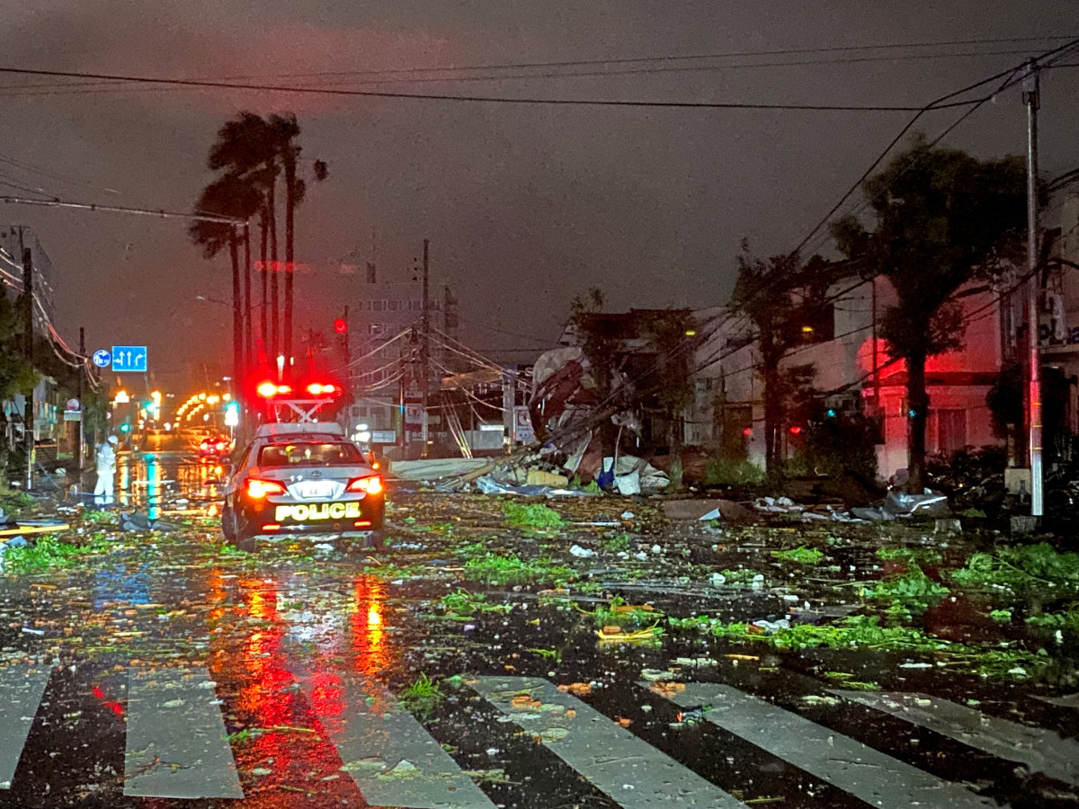A police car drives amid destruction from Typhoon Shanshan in Miyazaki city, Japan, on August 29, 2024. (TomokichiviaX/via REUTERS)