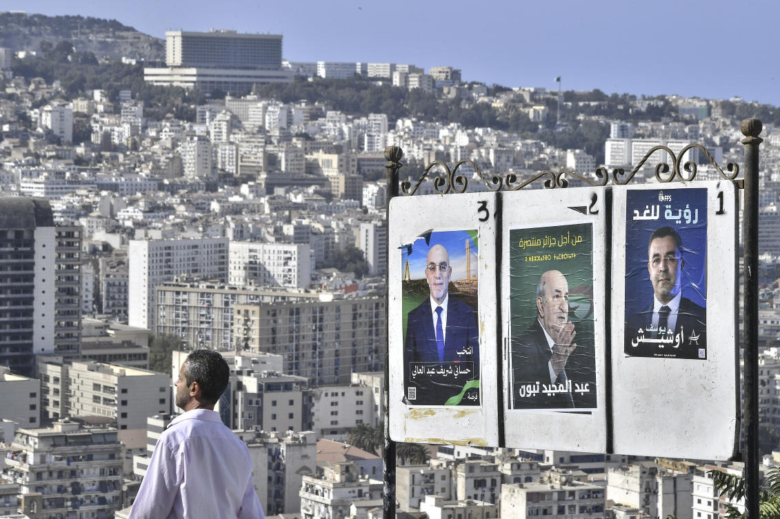 A man walks past electoral banners of presidential candidate, including President Abdelmadjid Tebboune, center, Tuesday, Aug. 27, 2024, in Algiers. (AP)