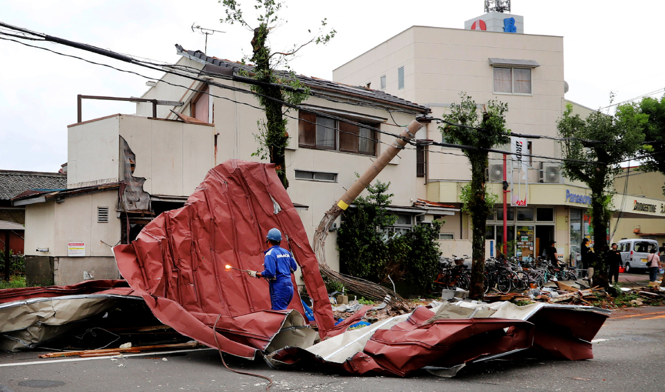 A worker removes debris blown away by strong winds caused by Typhoon Shanshan in Miyazaki on August 29, 2024. (AFP)
