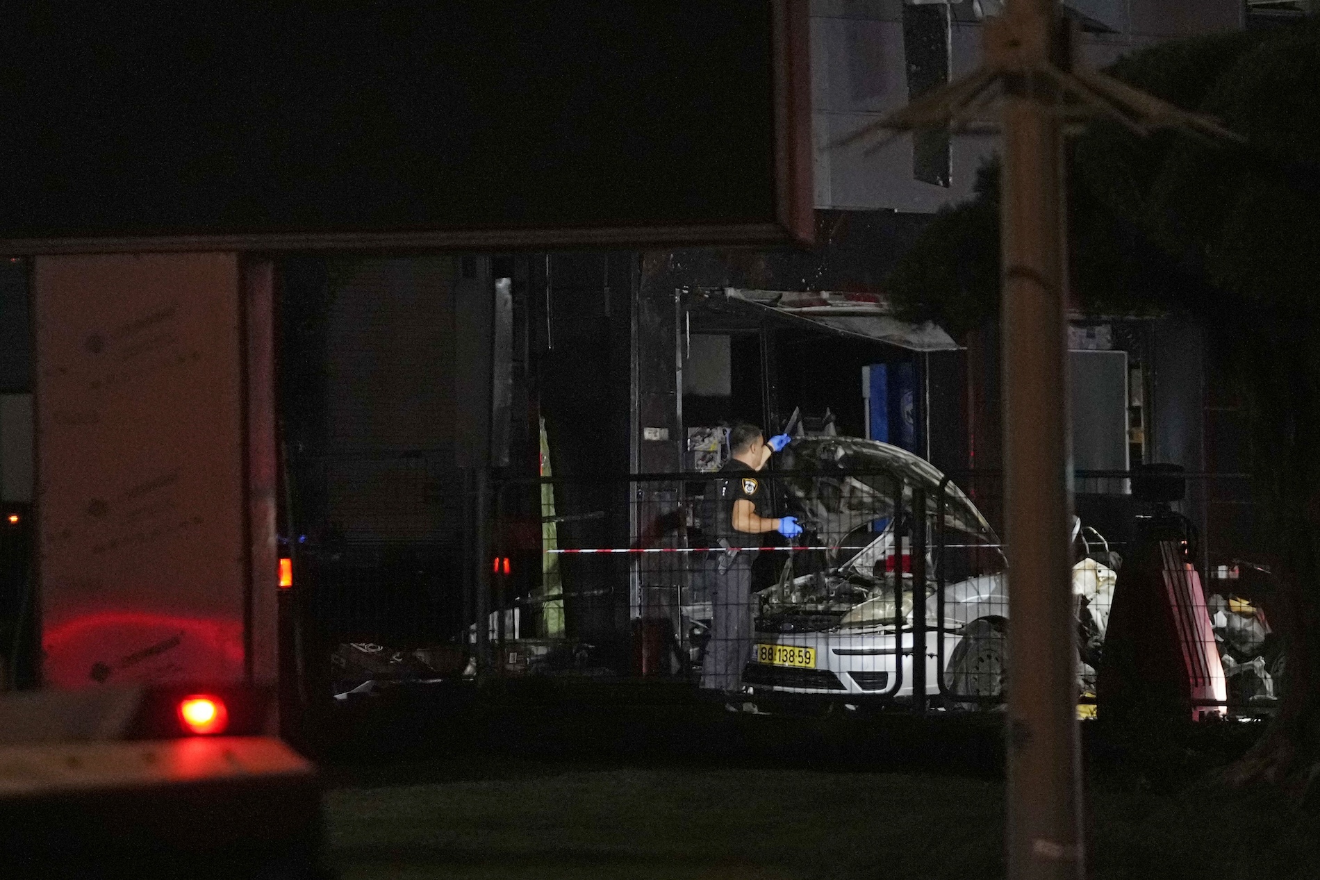 Israeli security forces examine a car after an explosion at a gas station in the West Bank settlement of Gush Etzion, Saturday, Aug. 31, 2024. (AP)
