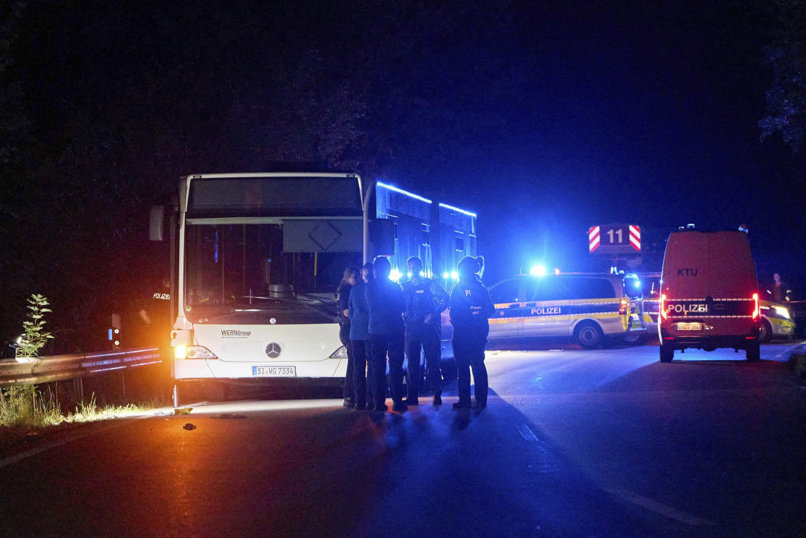 Police officers stand in front of a bus on a special route to a city festival in Siegen, Germany, Friday, Aug. 30, 2024, after a suspect allegedly attacked other passengers on the bus with a knife. (AP)